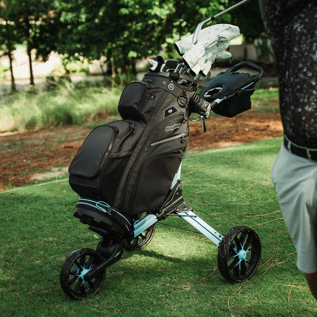 Ice Blue/White Bag Boy Nitron push cart carrying a black Bag Boy Chiller Pro bag