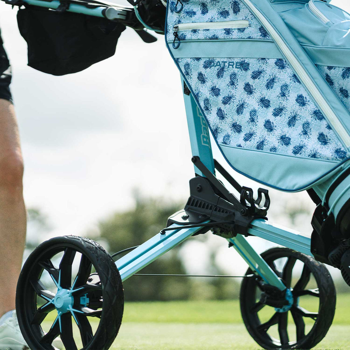 Ice Blue/White Bag Boy Nitron push cart wheels and frame close-up