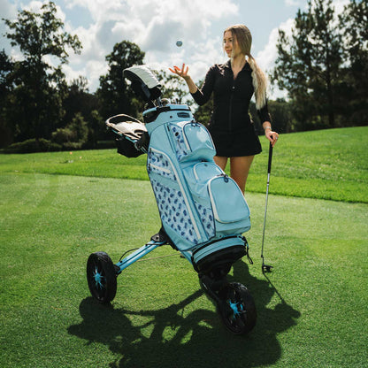 Ice Blue/White Bag Boy Nitron Auto-Open push cart on the golf course
