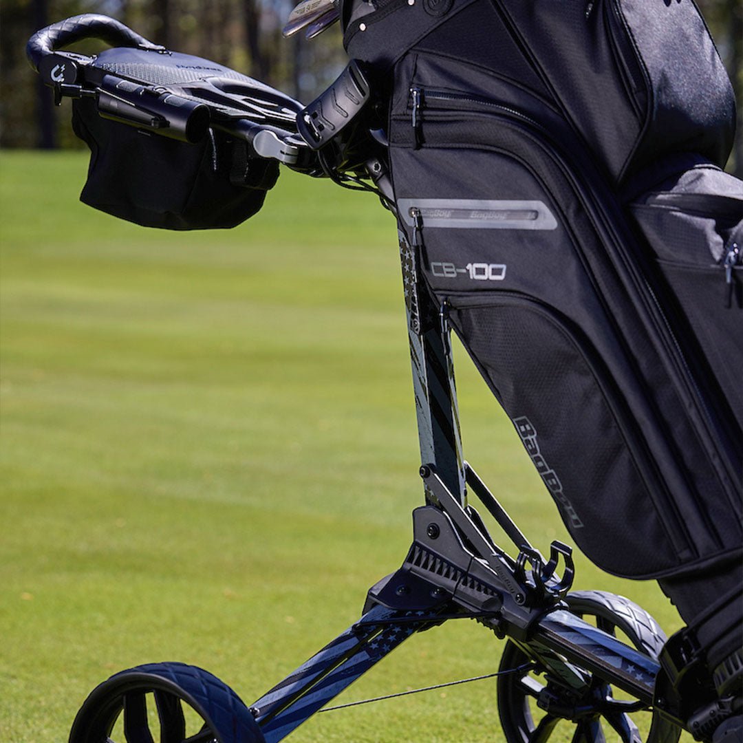 Gray/Black USA LTD Bag Boy Nitron push cart with golf bag on the course