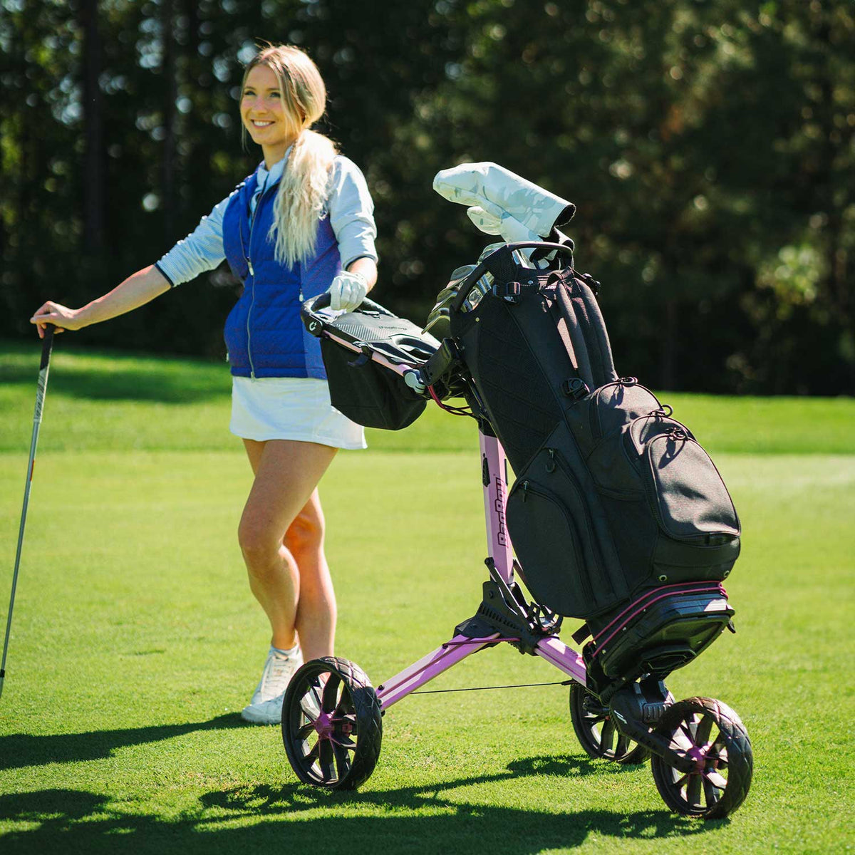 Pink/Wine Bag Boy Nitron Auto-Open push cart on the golf course